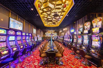 SOUL777 Casino Games — Enjoy nonstop entertainment A close-up shot of golden coins falling around a spinning roulette wheel, representing immersive casino action at SOUL777.